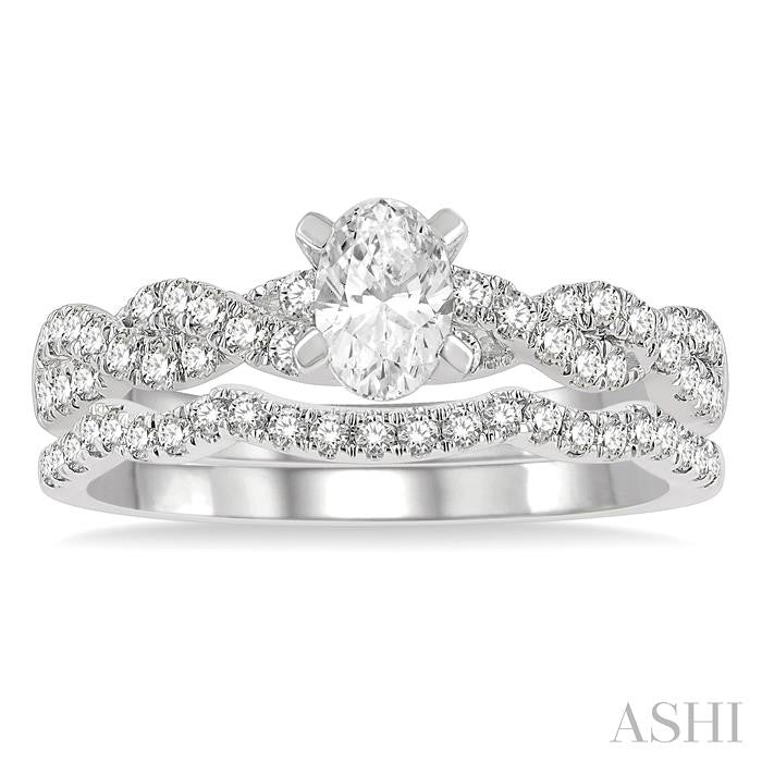 1 1/10 Ctw Diamond Wedding Set With 7/8 Ctw Twisted Shank Oval Cut Engagement Ring and 1/6 Ctw Curve Wedding Band in 14K White Gold