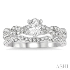 1 1/10 Ctw Diamond Wedding Set With 7/8 Ctw Twisted Shank Oval Cut Engagement Ring and 1/6 Ctw Curve Wedding Band in 14K White Gold