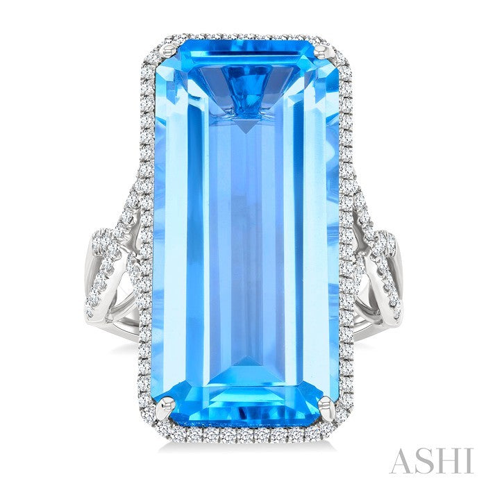 26x12 MM Emerald Cut Blue Topaz and 1/2 Ctw Round Cut Diamond Halo Semi-Precious Ring in 14K White Gold