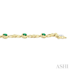 1/20 Ctw Oval Cut 4X3MM Emerald and Round Cut Diamond Precious Fashion Bracelet in 10K Yellow Gold