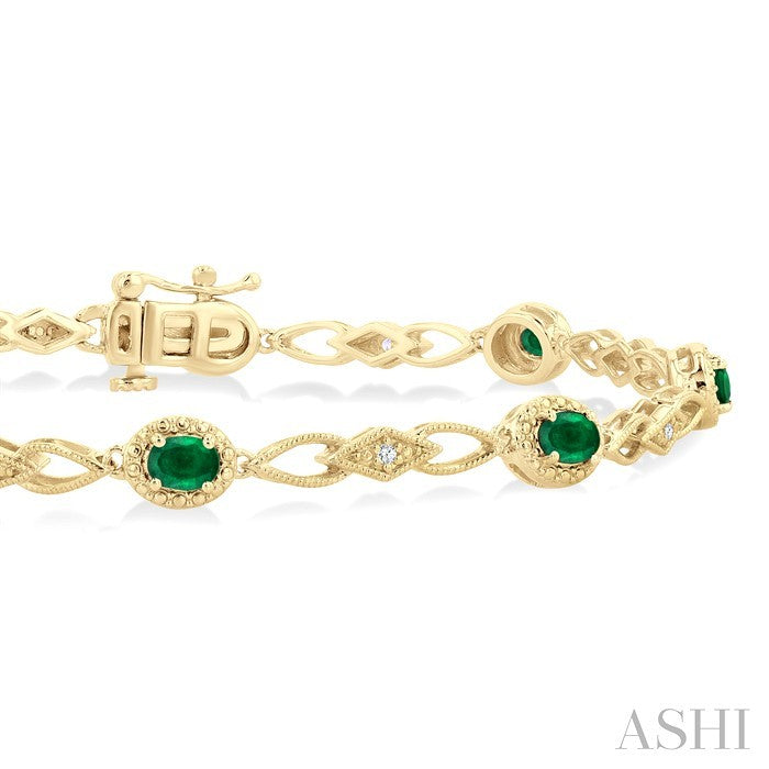 1/20 Ctw Oval Cut 4X3MM Emerald and Round Cut Diamond Precious Fashion Bracelet in 10K Yellow Gold