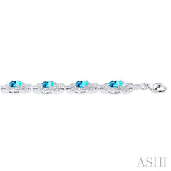 7x5 MM Oval Shape Blue Topaz and 1/10 Ctw Round Cut Diamond Semi-Precious Bracelet in Sterling Silver