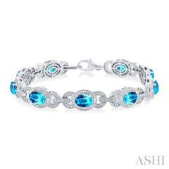 7x5 MM Oval Shape Blue Topaz and 1/10 Ctw Round Cut Diamond Semi-Precious Bracelet in Sterling Silver