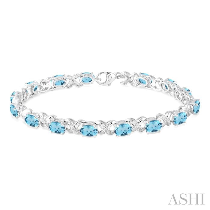 7x5 MM Oval Cut Blue Topaz and 1/20 Ctw Round Cut Diamond Fashion Bracelet in Sterling Silver