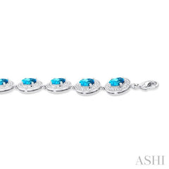 7x5 MM Oval Shape Blue Topaz and 1/10 Ctw Round Cut Diamond Semi-Precious Bracelet in Sterling Silver