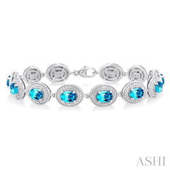 7x5 MM Oval Shape Blue Topaz and 1/10 Ctw Round Cut Diamond Semi-Precious Bracelet in Sterling Silver