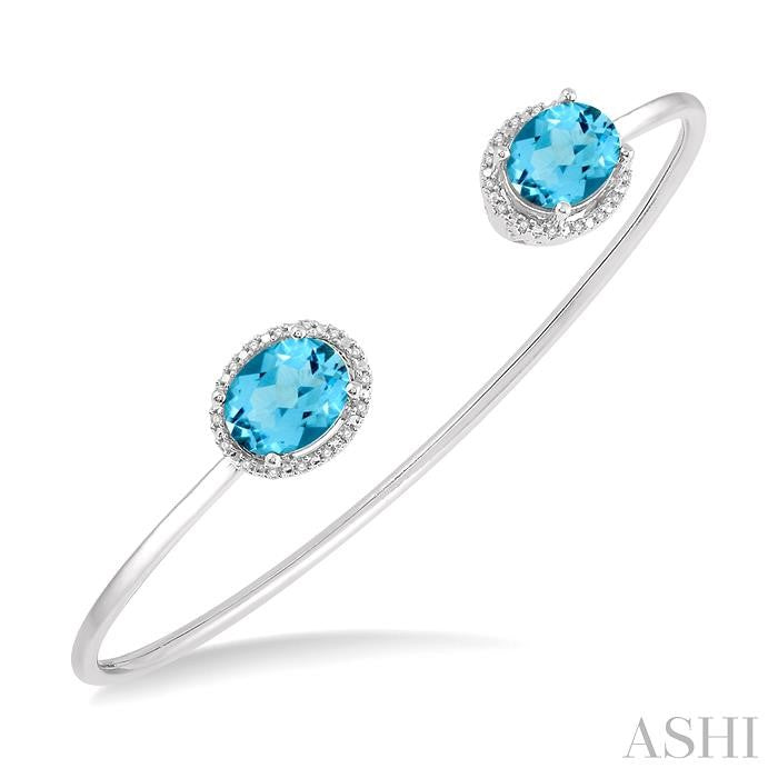9x7 MM Oval Shape Blue Topaz and 1/10 Ctw Round Cut Diamond Bangle in Sterling Silver