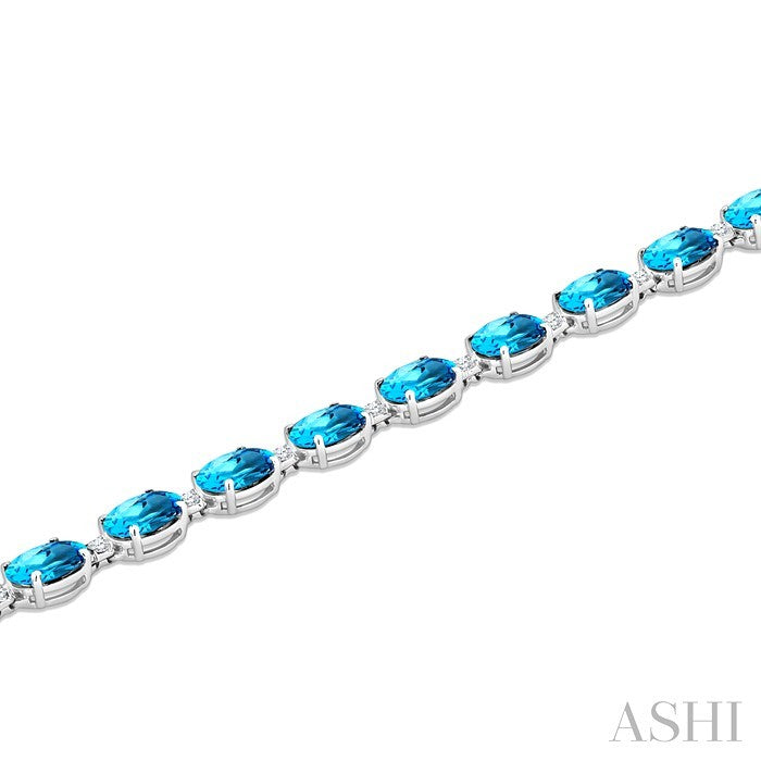 7X5 MM Oval Shape Blue Topaz and 1/10 Ctw Round Cut Diamond Semi-Precious Bracelet in Sterling Silver