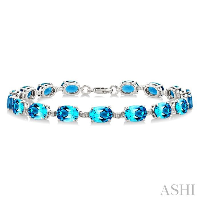 7X5 MM Oval Shape Blue Topaz and 1/10 Ctw Round Cut Diamond Semi-Precious Bracelet in Sterling Silver
